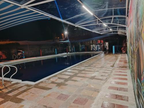 a swimming pool in a building at night at Leño Verde in Espinal