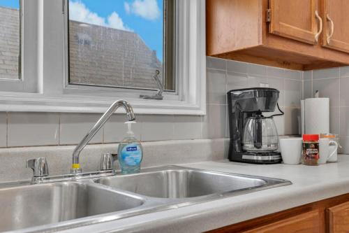 un fregadero con una botella de jabón. en Bright 3BR Upper Level Stay • Pet Friendly, en Windsor