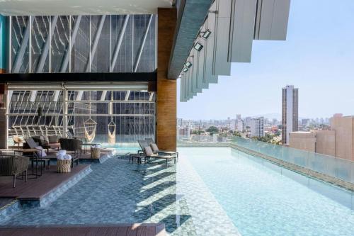 a swimming pool on the roof of a building at AC Hotel by Marriott Guadalajara Mexico in Guadalajara