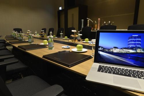 a laptop computer sitting on top of a long table at Wyndham Grand Istanbul Europe in Istanbul