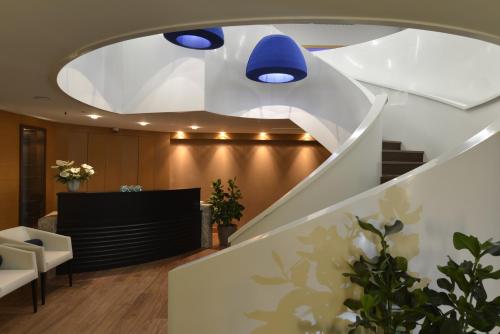 a staircase in a lobby with a blue ceiling at Wyndham Grand Istanbul Europe in Istanbul