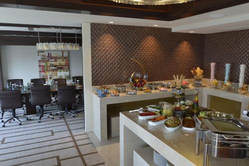 a restaurant with a buffet with food on a counter at Wyndham Grand Istanbul Europe in Istanbul