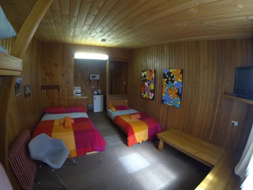 a room with two beds and a tv in it at Bunkhouse Motel in Cooma