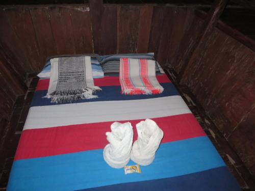 a bed with two pairs of underwear on it at Native Village Inn in Banaue