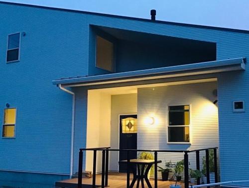 a blue house with a table in front of it at SHIMAGO SURFRIDER - Vacation STAY 85442v in Amakusa