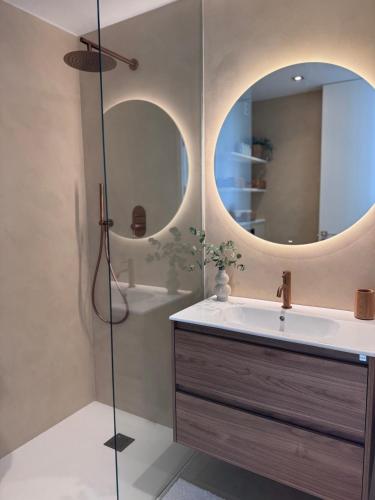 a bathroom with a sink and a mirror at Apartment front line in Moraira