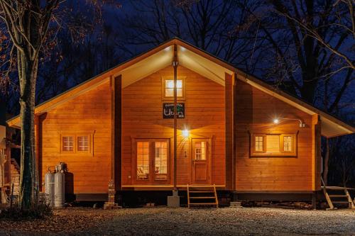 a wooden cabin at night with the lights on at Private Villa Utan in Iiyama