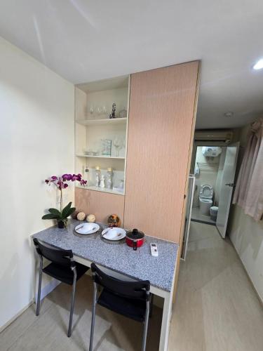 a small kitchen with a table and two chairs at Affordable Private Studio Al Reem Island in Abu Dhabi