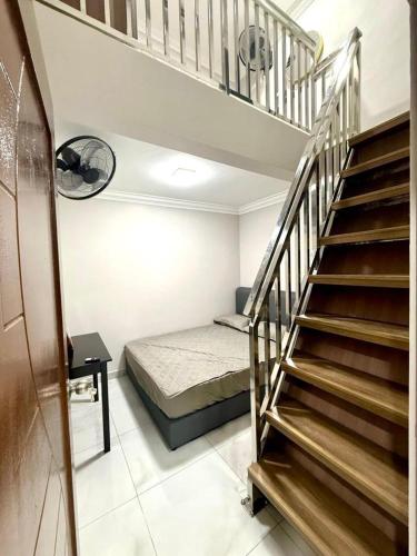 a room with a staircase and a bed in it at Guest House Taman Universiti 3 bedroom in Skudai