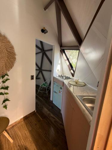 a small kitchen with a sink and a stove at Domos munaQ Dusty in San Javier
