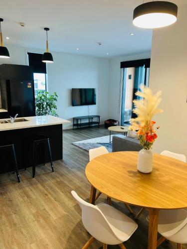 a dining room and living room with a table and chairs at Lakewood Apartment in Cambridge