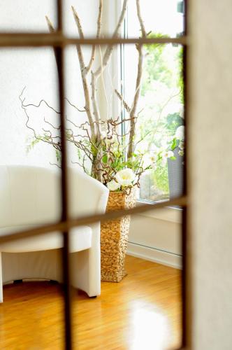a vase with a plant in a window at Hotel Herrenhof in Lübeck