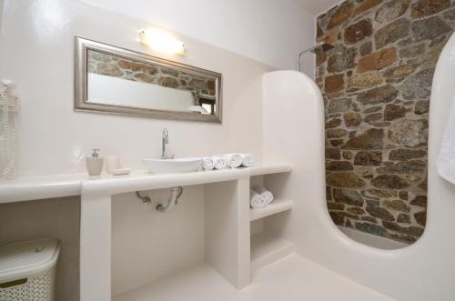a bathroom with a sink and a mirror at Casa Borealis in Naxos Chora