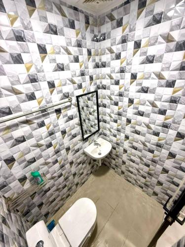 a bathroom with a sink and a mirror and a toilet at Guest House Taman Universiti 3 bedroom in Skudai