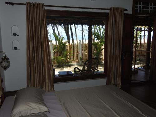 Postel nebo postele na pokoji v ubytování Alleppey Beach Garden