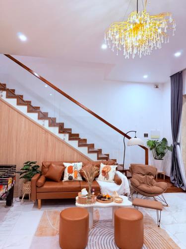 a living room with a couch and a chandelier at Solia Villa in Da Nang