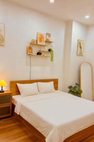a bedroom with a large white bed in a room at Solia Villa in Danang