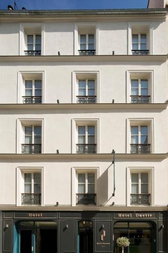 a large white building with windows and a facade at Hotel Duette Paris in Paris