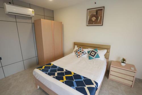 a small bedroom with a bed and a night stand at Samyukta resort in Gogāpur