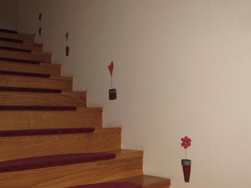 a staircase with a flower in a vase on the wall at Smještaj Slavonija in Daruvar