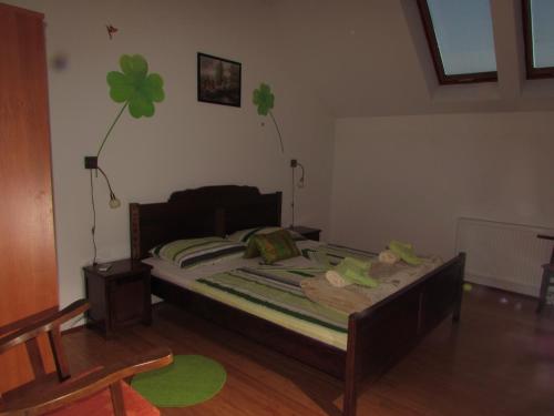 a bedroom with a bed with a four leaf clover on the wall at Smještaj Slavonija in Daruvar