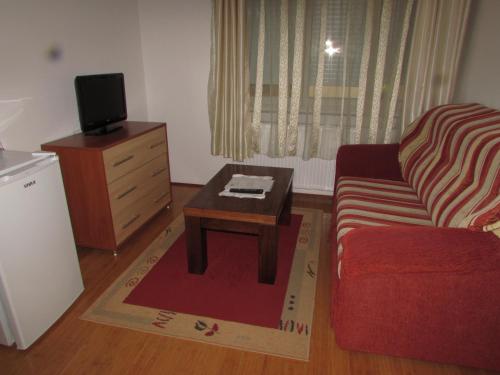 a living room with a couch and a coffee table at Smještaj Slavonija in Daruvar