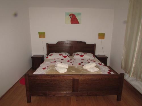 a bedroom with a bed with roses on it at Smještaj Slavonija in Daruvar