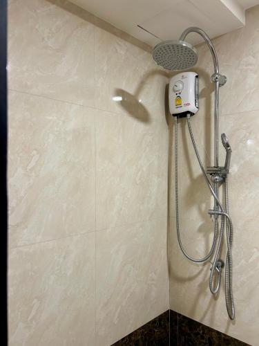 a shower with a shower head in a bathroom at Hillside-Seashore Space Mai Khao Beach in Mai Khao Beach