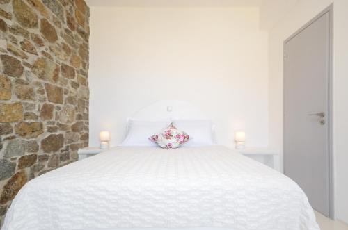 a white bed with a pillow on top of it at Casa Borealis in Naxos Chora