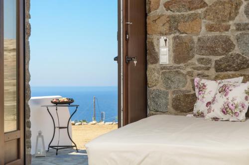 a bedroom with a bed and a view of the ocean at Casa Borealis in Naxos Chora