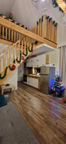 a kitchen with a christmas tree in a living room at Domek na Folwarku z jacuzzi in Tarnawa Dolna