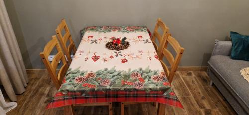 a table with a christmas table cloth on it at Domek na Folwarku z jacuzzi in Tarnawa Dolna