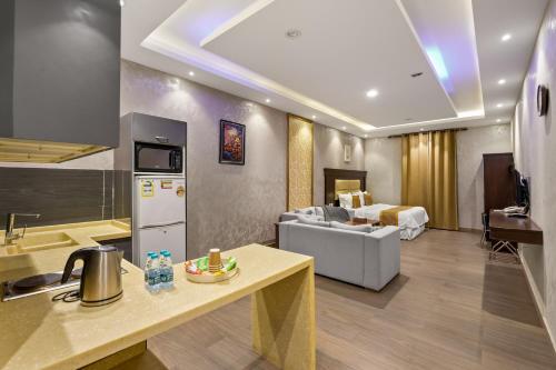 a kitchen and a living room with a couch at Grand Residence in Riyadh
