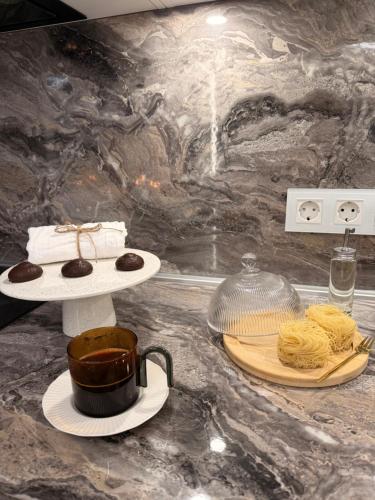 a counter with a plate of food and a pot of food at JE downtown suite in Jelgava