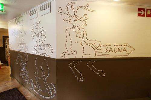 a wall with a drawing of a moose on it at Hotel Hullu Poro in Levi