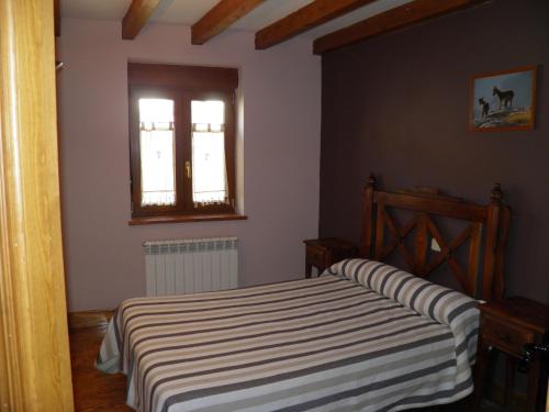 a bedroom with a bed and a window at Mirasierra II Y III in Navarredonda de Gredos