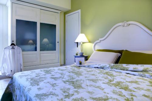 a bedroom with a bed with a white bedspread at Avra Private Suites in Lassi
