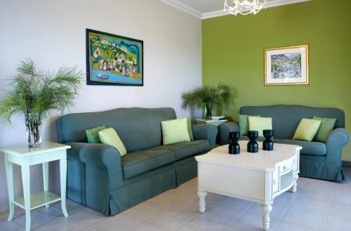 a living room with two couches and a table at Avra Private Suites in Lassi