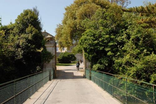 a person riding a bike on a bridge at Hotel Napoleon in Île dʼAix