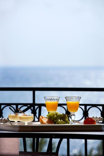 a tray with two drinks and food on a table at Avra Private Suites in Lassi