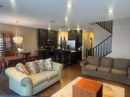 a living room with a couch and a kitchen at Panorama Haven in Calgary
