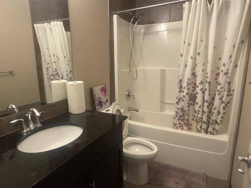 a bathroom with a sink and a toilet and a shower at Panorama Haven in Calgary