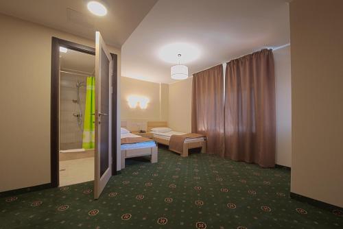 a hotel room with a bed and a bathroom at Advenus Hotel in Lviv