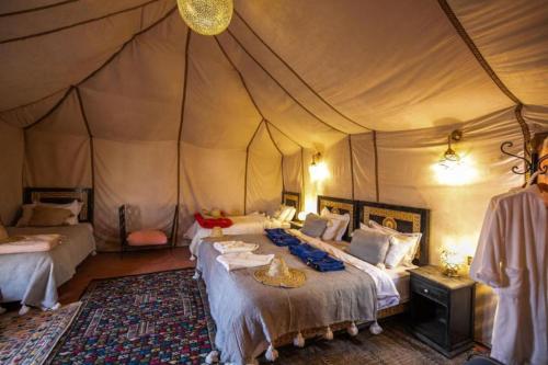 Giường trong phòng chung tại Experience Luxury Desert Camp