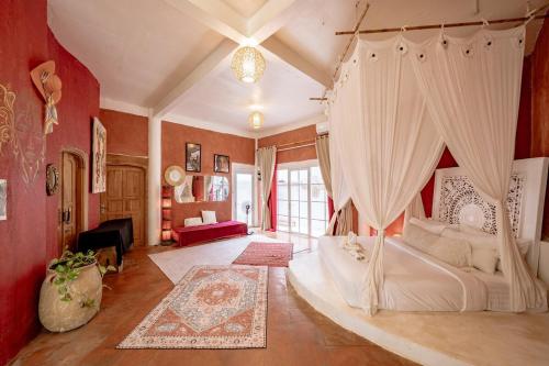 a bedroom with a bed with a canopy at 4BR Villa for Families - 5 Min to Thomas Beach in Ungasan