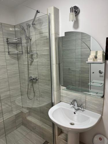 a bathroom with a sink and a glass shower at Royal Transylvanian Castle - near Banffi in Gherla