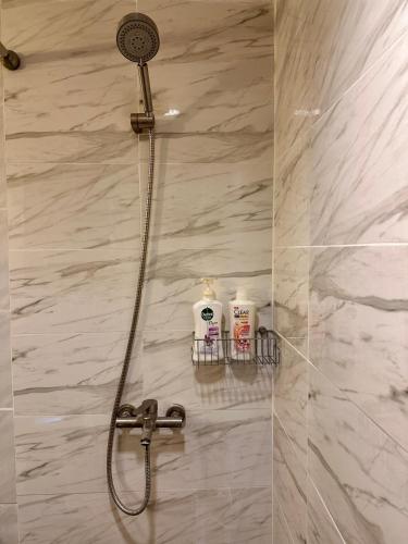 a shower with a shower head in a bathroom at Spacious room in Sukhumvit Nana in Bangkok