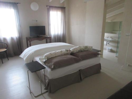 a bedroom with a bed and a couch and a television at Villa Laura in Cocconi