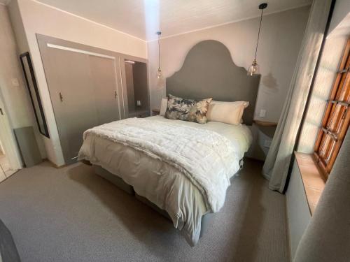 a bedroom with a bed with a pillow on it at Critchley Hackle - Deluxe garden units in Dullstroom