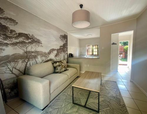 a living room with a couch and a table at Critchley Hackle - Deluxe garden units in Dullstroom